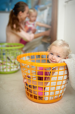 Buy stock photo Happy baby, portrait and laundry basket with mom for fun childhood, game or chore day at home. Young, little girl and smile in bucket with mother or clothing by washing machine for hygiene or care