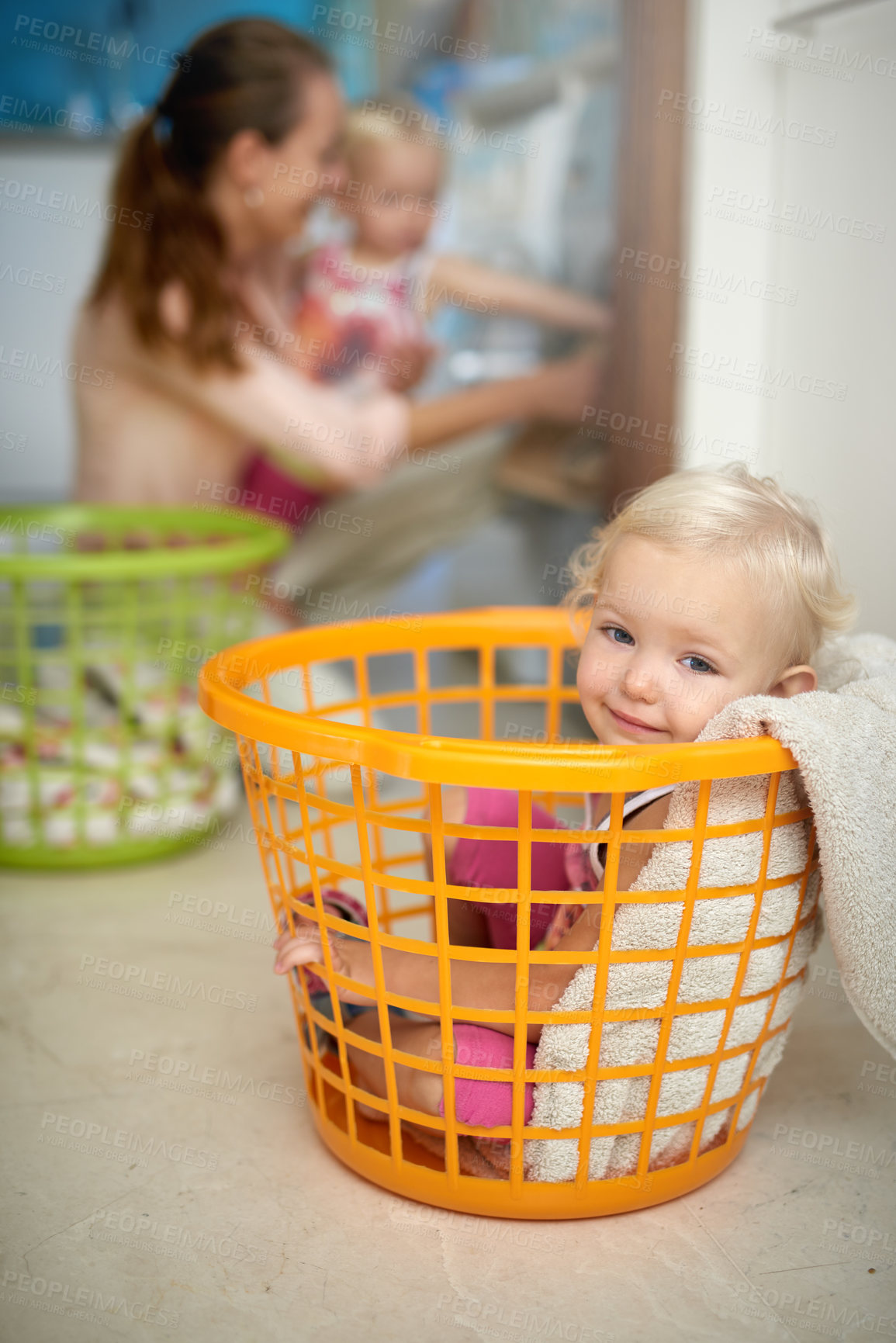 Buy stock photo Happy baby, portrait and laundry basket with mom for fun childhood, game or chore day at home. Young, little girl and smile in bucket with mother or clothing by washing machine for hygiene or care