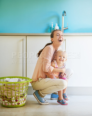Buy stock photo Shot of a mother and daughter having fun while doing housework