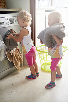 Buy stock photo Kids, washing machine and siblings with laundry in house for learning, playing or fun bonding together. Cleaning, games and children help with towels at home for child development, housework or chore