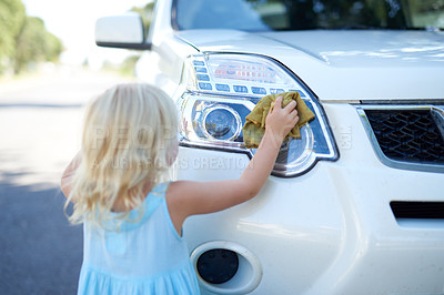 Buy stock photo Shot of a young girl washing a car outside