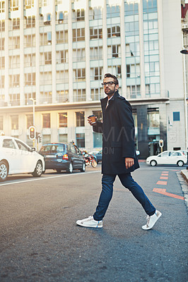 Buy stock photo Shot of a stylish man crossing a city street