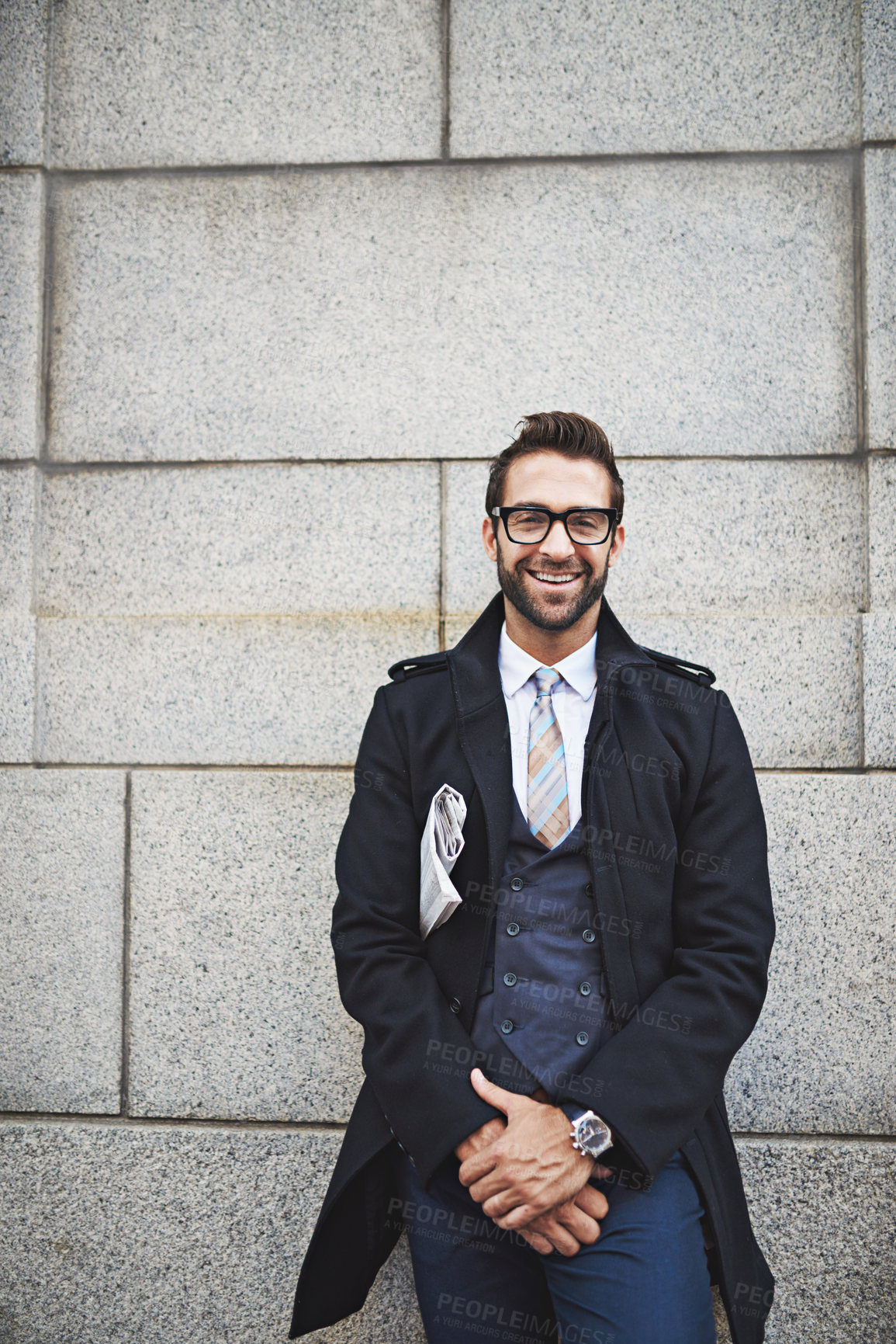 Buy stock photo Portrait, business and man in city, newspaper and smile with happiness, entrepreneur and glasses. Face, employee and consultant on wall, formal and corporate fashion with eyewear, pride or confidence