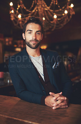 Buy stock photo Cropped portrait of a young man sitting in a bar
