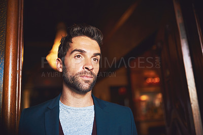 Buy stock photo Cropped shot of a young man standing in a bar