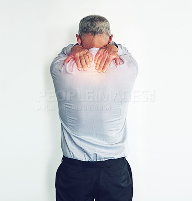 Buy stock photo Studio shot of a mature man experiencing neck ache against a white background