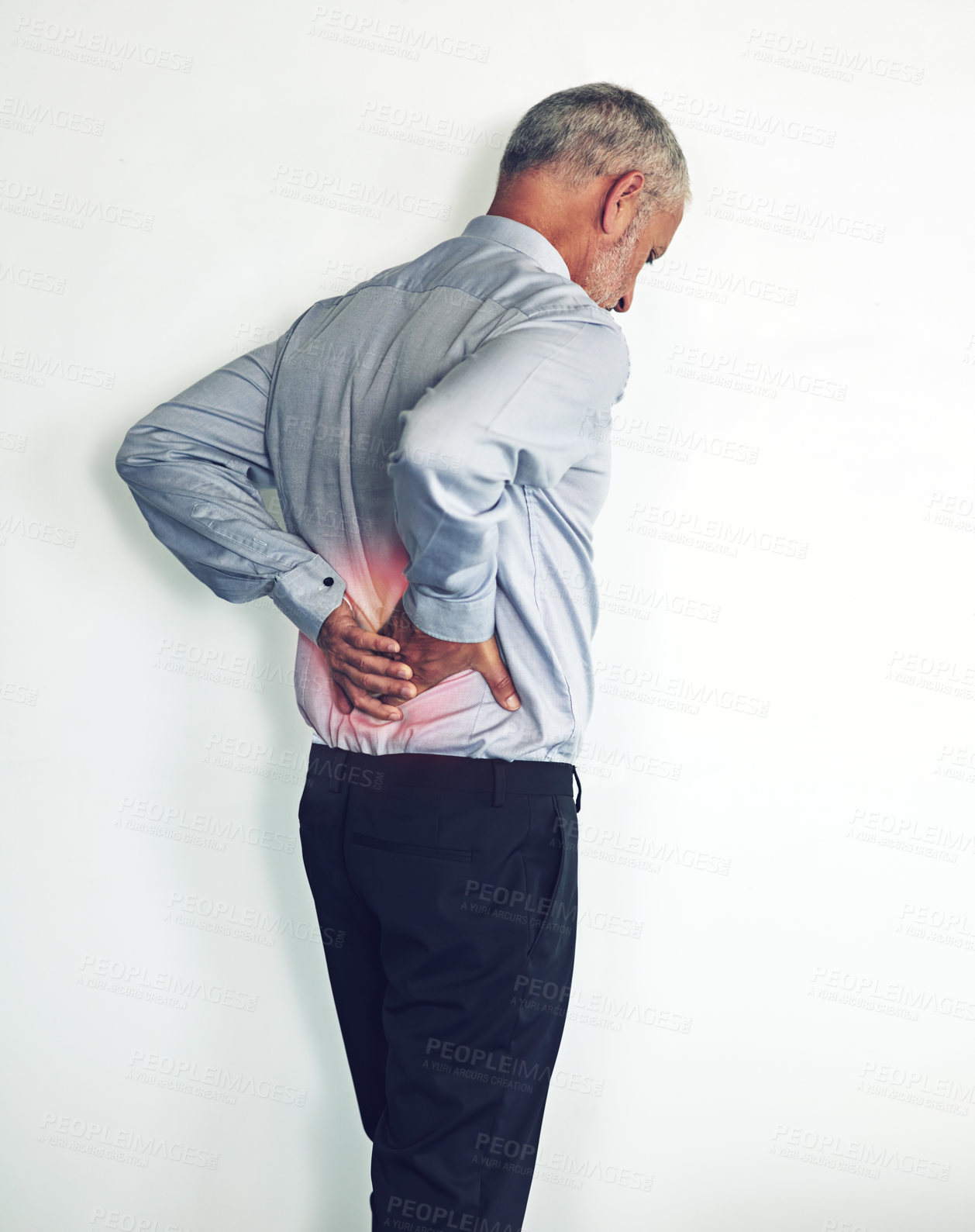 Buy stock photo Studio shot of a mature man experiencing muscular strain