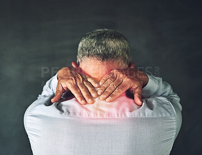 Buy stock photo Studio shot of a mature man experiencing neck ache against a black background