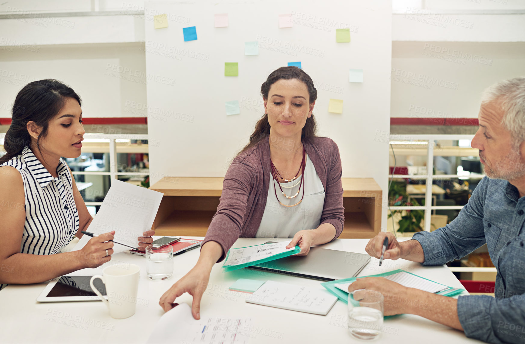 Buy stock photo Shot of a team of colleagues having a meeting in a modern office