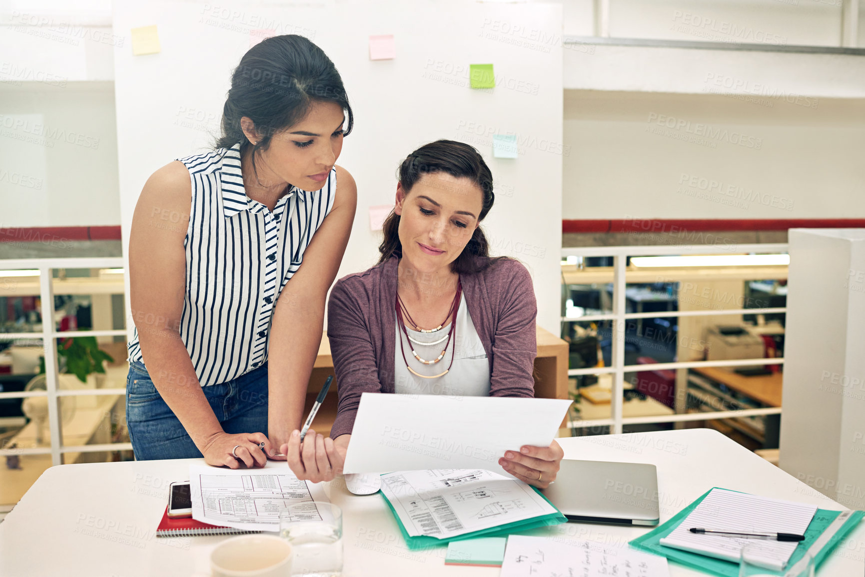 Buy stock photo Shot of a two colleagues having a meeting in a modern office