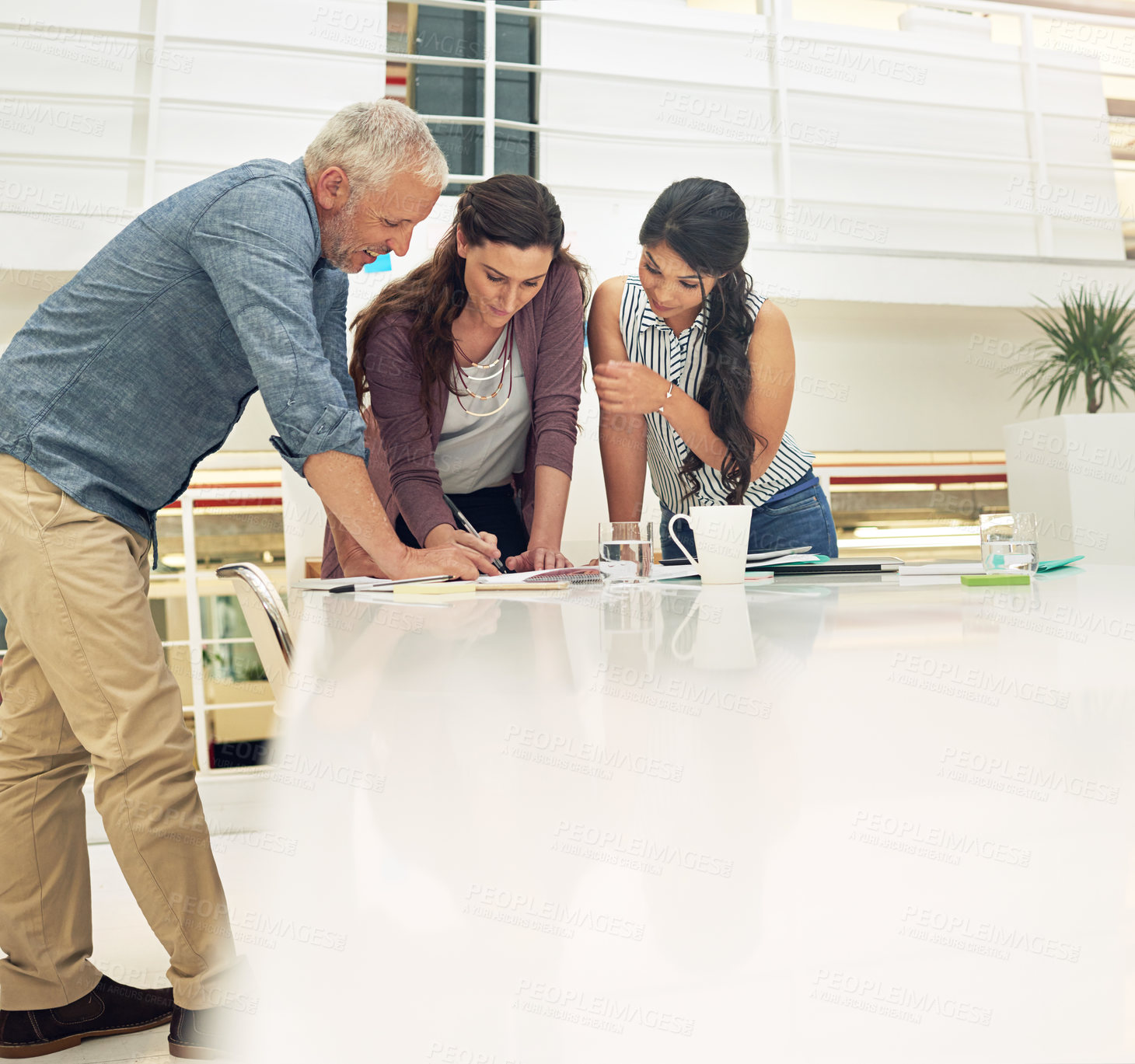 Buy stock photo Shot of a team of colleagues having a meeting in a modern office