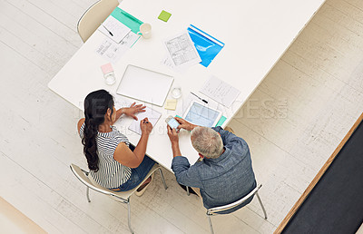 Buy stock photo Shot of a two colleagues having a meeting in a modern office