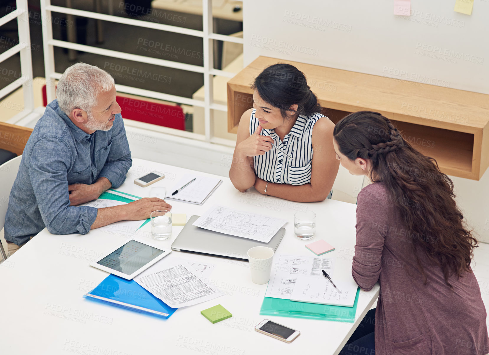 Buy stock photo Shot of a team of colleagues having a meeting in a modern office