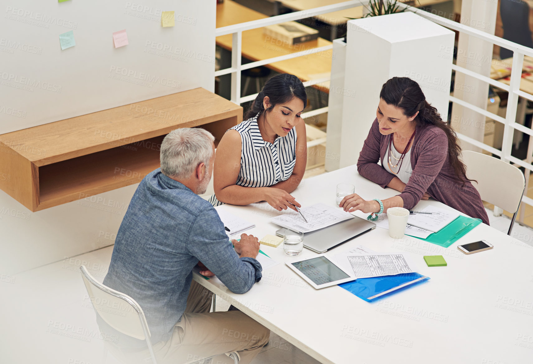 Buy stock photo Shot of a team of colleagues having a meeting in a modern office