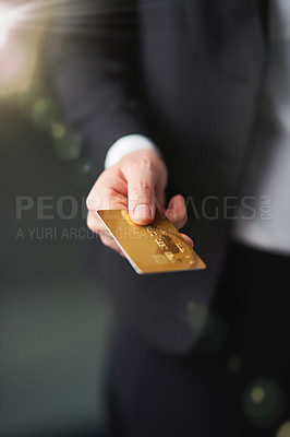 Buy stock photo Shot of a businessman holding out a credit card