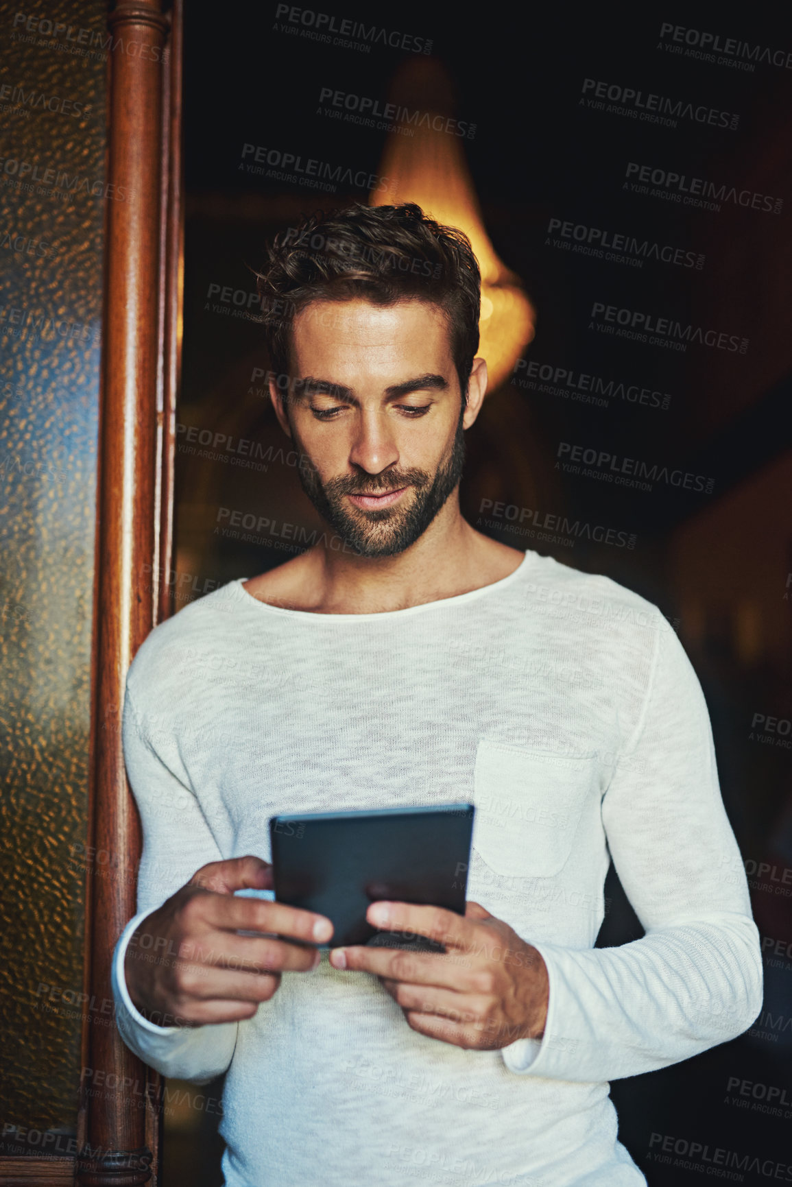 Buy stock photo Shot of a handsome man using a digital tablet