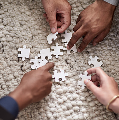 Buy stock photo Cropped shot of a group of people fitting puzzle pieces together