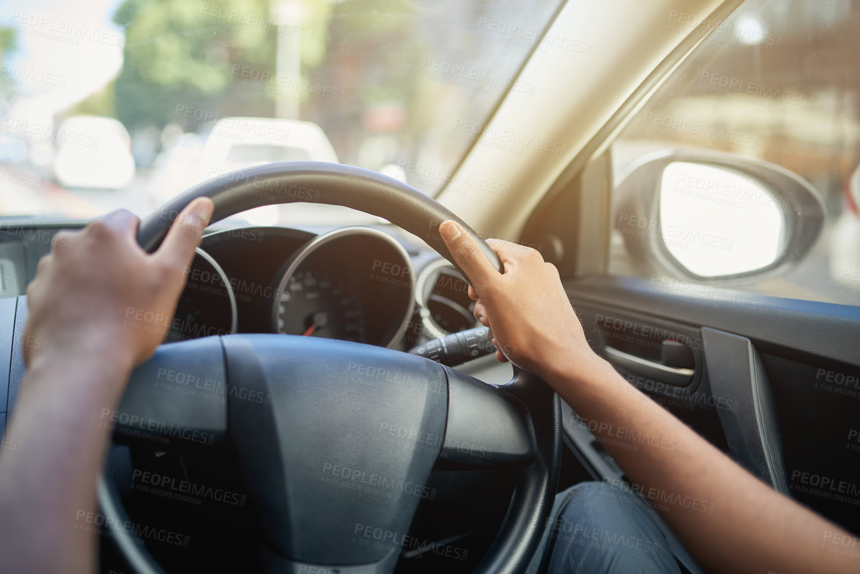 Buy stock photo Cropped shot of a man’s hands at the 10 and 2 position on a steering wheel of a car