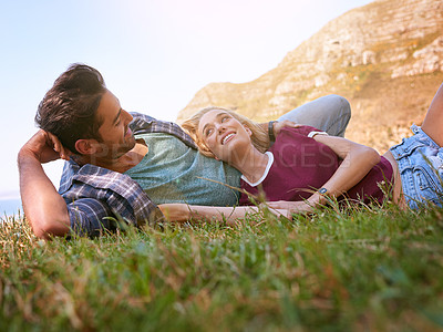 Buy stock photo Shot of an affectionate young couple enjoying a day outdoors