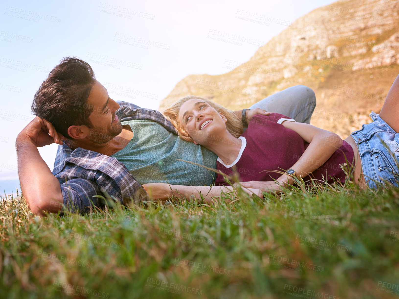 Buy stock photo Shot of an affectionate young couple enjoying a day outdoors