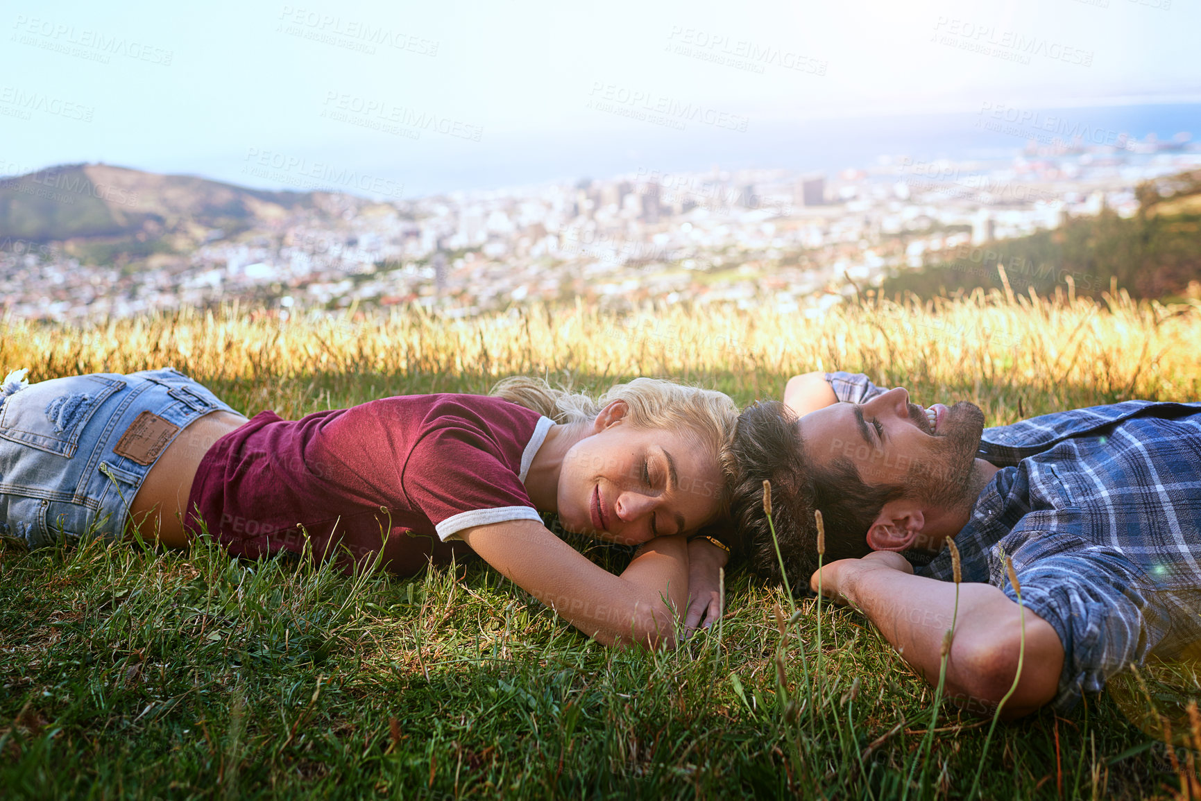 Buy stock photo Shot of an affectionate young couple enjoying a day outdoors