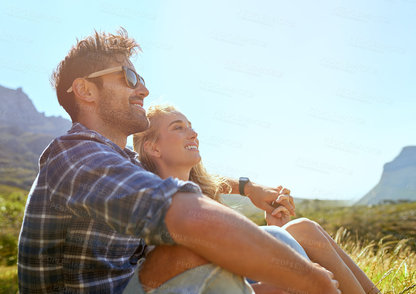 Buy stock photo Shot of an affectionate young couple enjoying a day outdoors