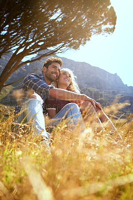 Buy stock photo Shot of an affectionate young couple enjoying a day outdoors