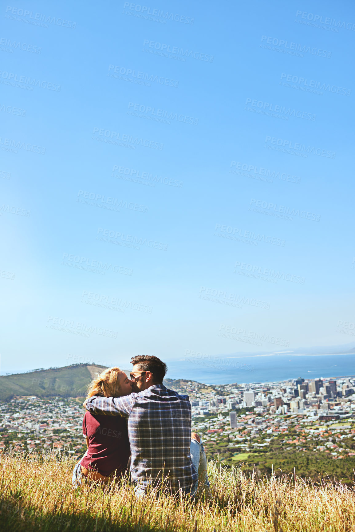 Buy stock photo Shot of an affectionate young couple enjoying a day outdoors