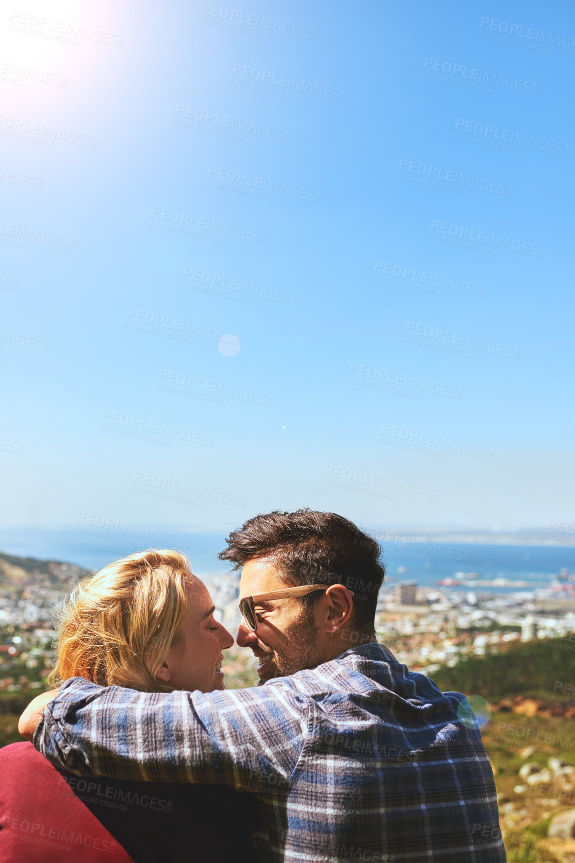 Buy stock photo Shot of an affectionate young couple enjoying a day outdoors