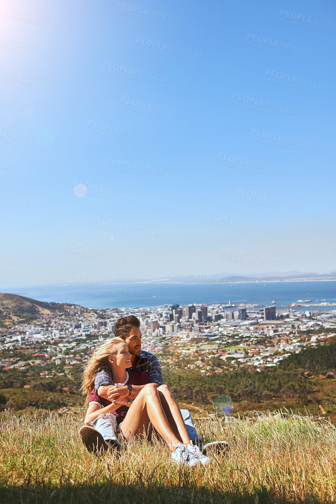 Buy stock photo Shot of an affectionate young couple enjoying a day outdoors