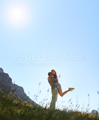 Buy stock photo Shot of an affectionate young couple enjoying a day outdoors