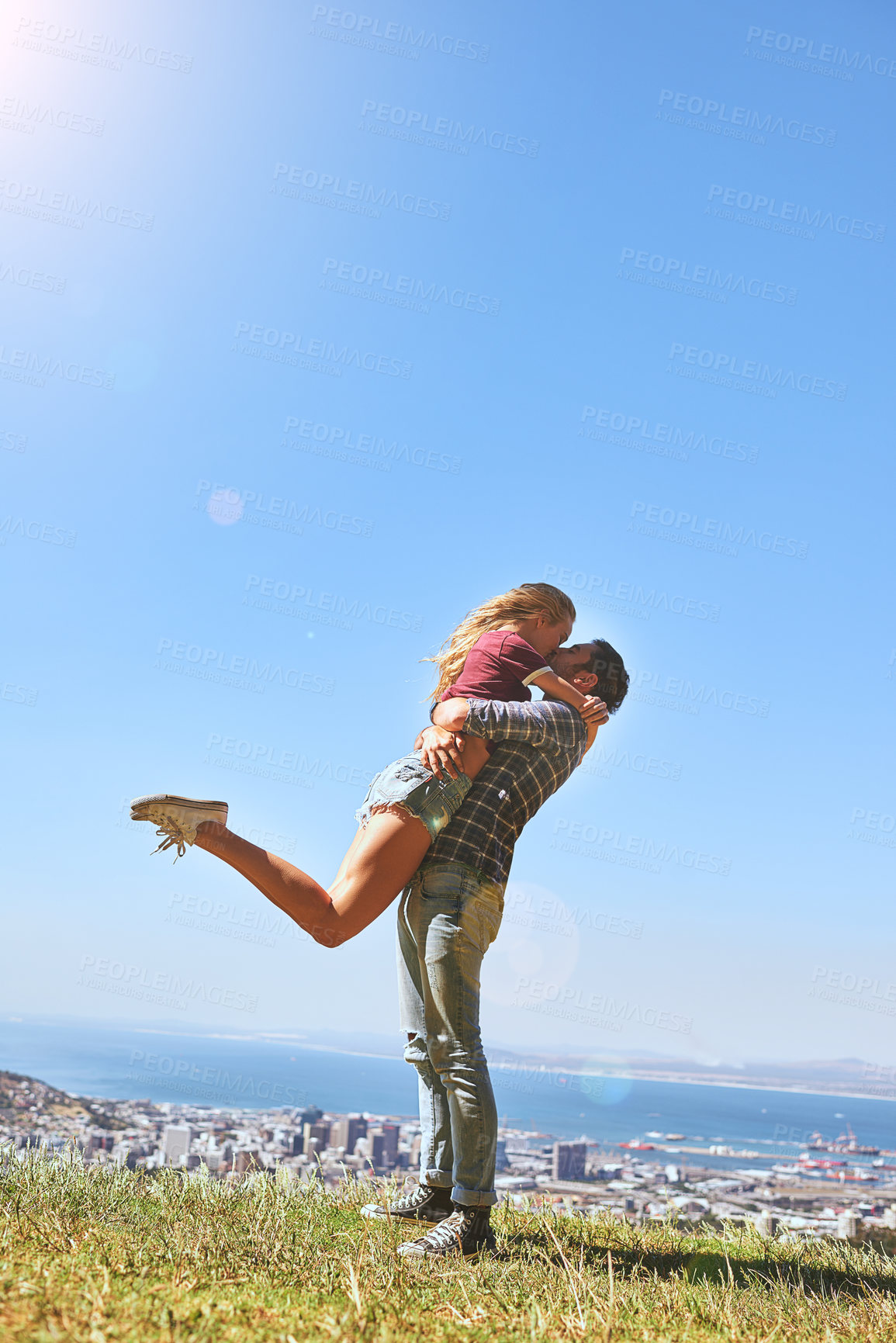 Buy stock photo Shot of an affectionate young couple enjoying a day outdoors