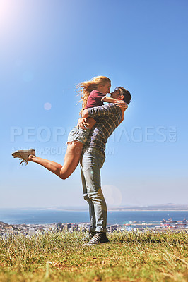 Buy stock photo Shot of an affectionate young couple enjoying a day outdoors