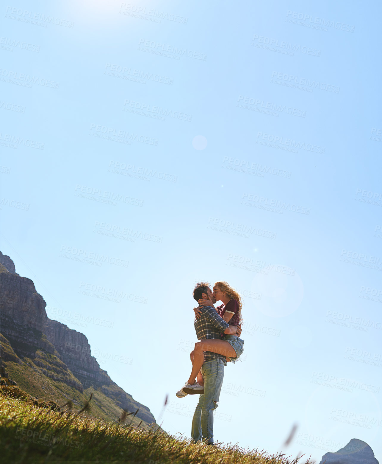 Buy stock photo Mountain, romance and kiss with couple for blue sky, love and having fun together. Valentines day, hug and low angle mockup space for man, woman and nature date for commitment and anniversary