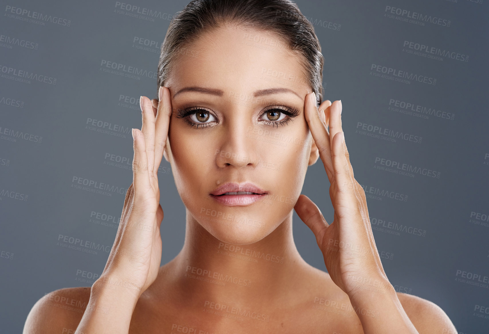 Buy stock photo Cropped shot of a beautiful young woman posing in the studio