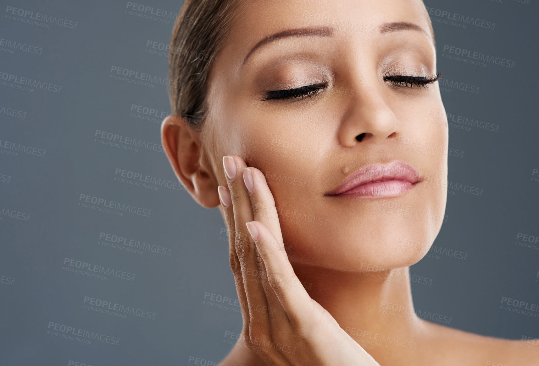 Buy stock photo Cropped shot of a beautiful young woman posing in the studio