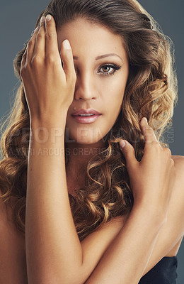 Buy stock photo Shot of a beautiful young lady posing against a grey background