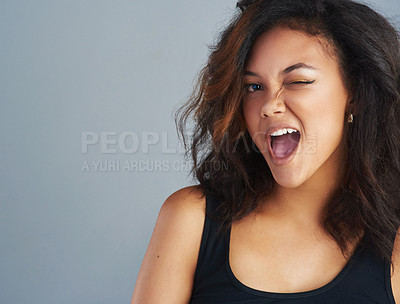 Buy stock photo Portrait of an attractive young woman posing against a gray background