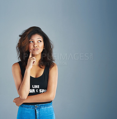 Buy stock photo Shot of an attractive young woman posing against a gray background