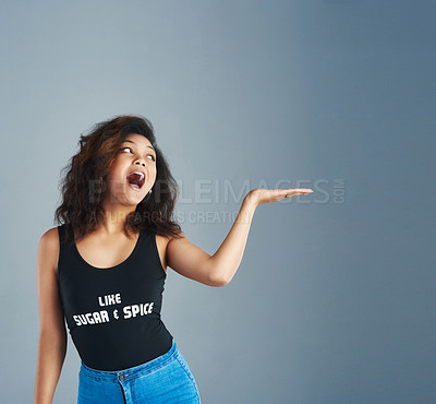 Buy stock photo Shot of an attractive young woman posing against a gray background