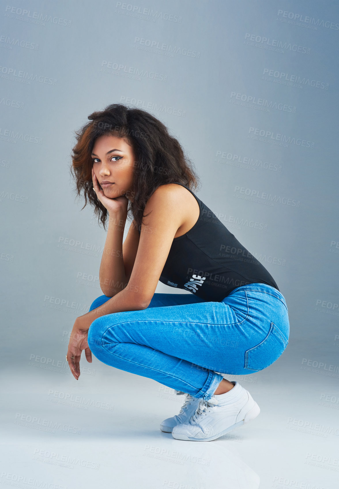 Buy stock photo Portrait of an attractive young woman posing against a gray background