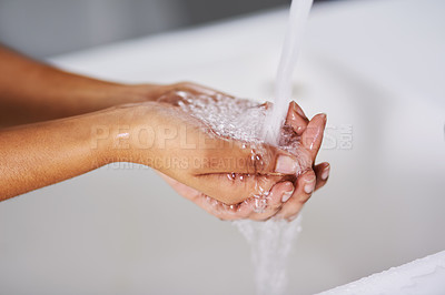 Buy stock photo Cropped shot of a woman washing her hands at a sink
