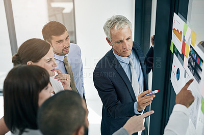 Buy stock photo Shot of a group of businesspeople having an office meeting