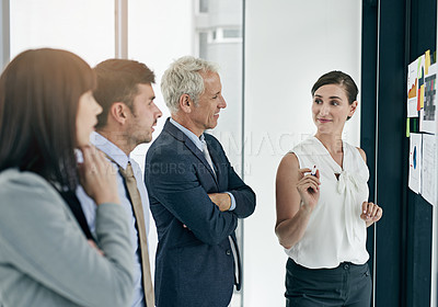 Buy stock photo Shot of a woman giving a presentation to colleagues in an office