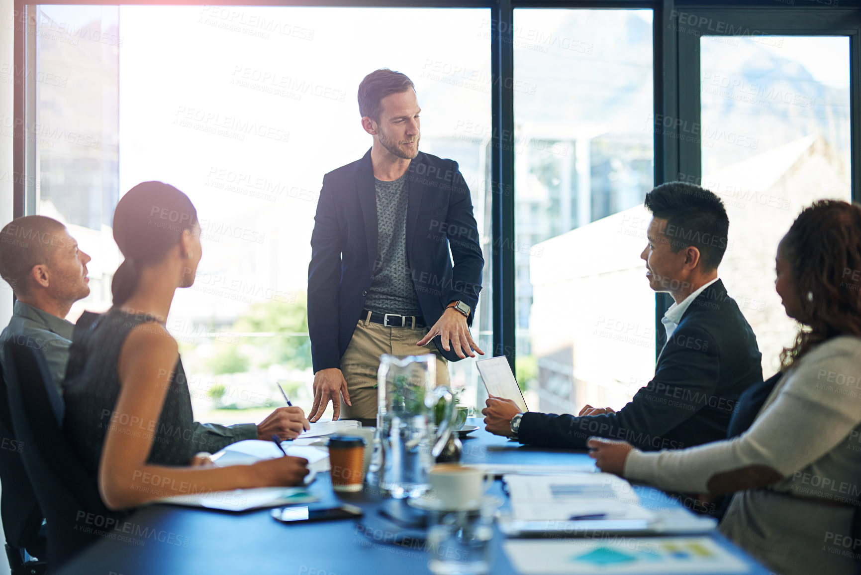 Buy stock photo Meeting, presentation and man in office with proposal, discussion and leadership for team growth. Ideas, development and business people in conference room with advice, strategy or project management