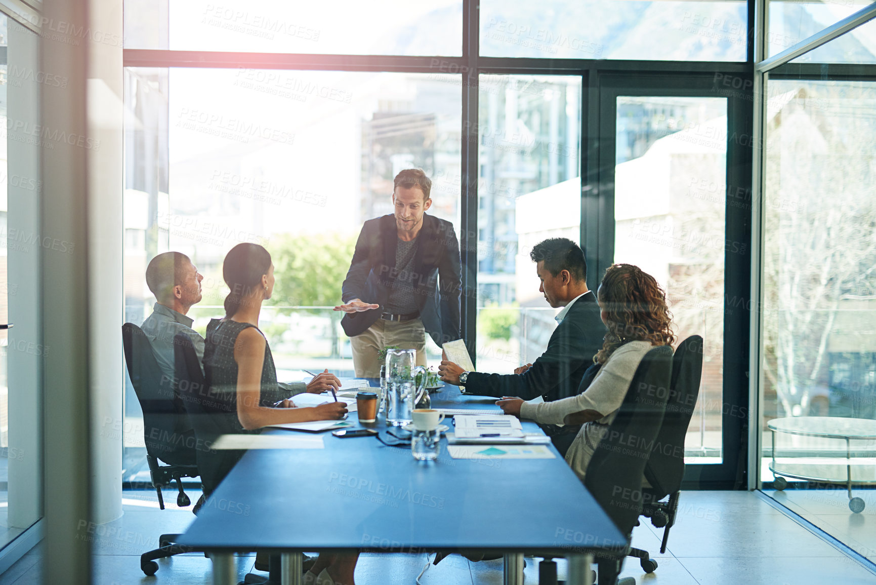 Buy stock photo Shot of a group of businesspeople meeting in the boardroom