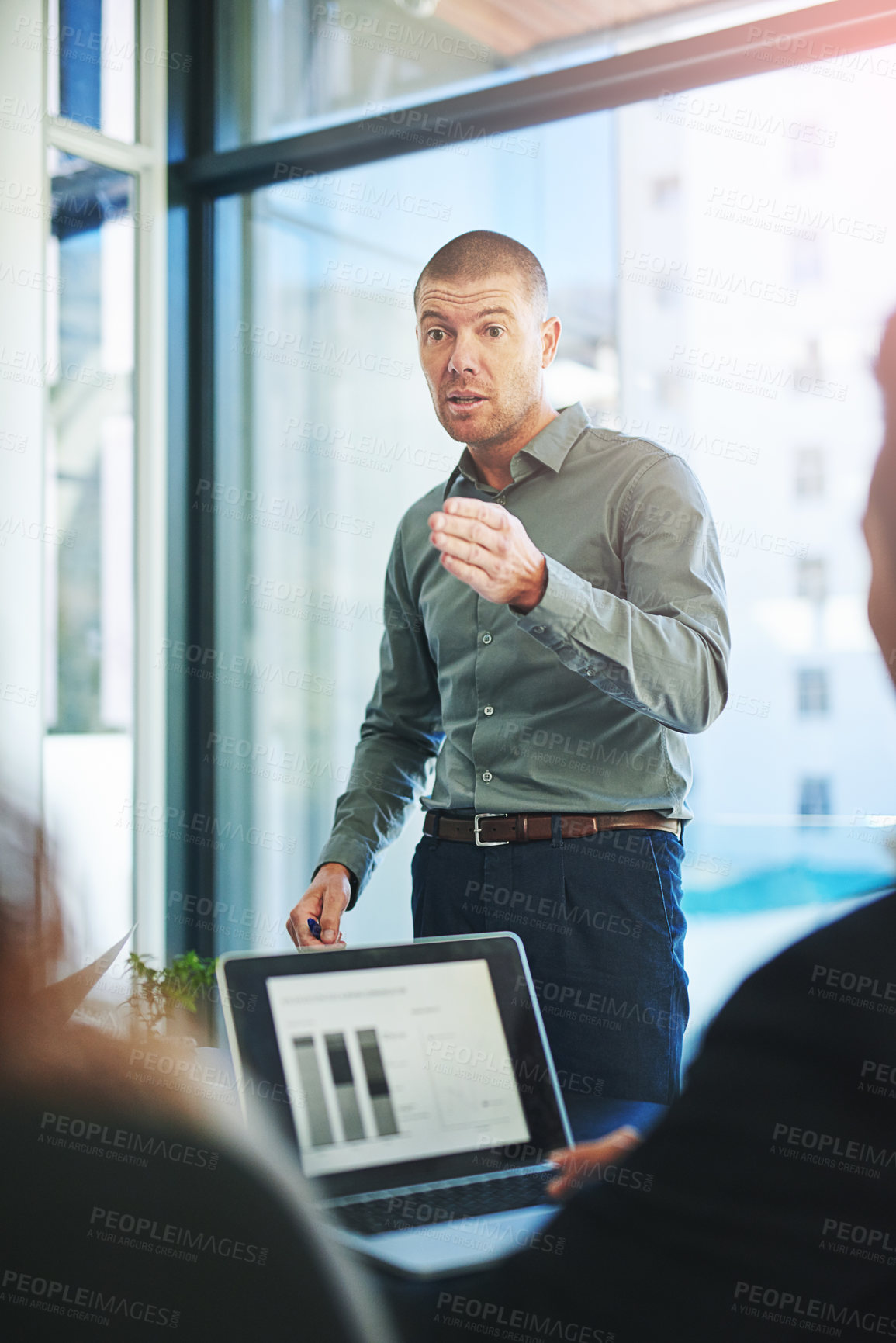 Buy stock photo Shot of a group of businesspeople meeting in the boardroom