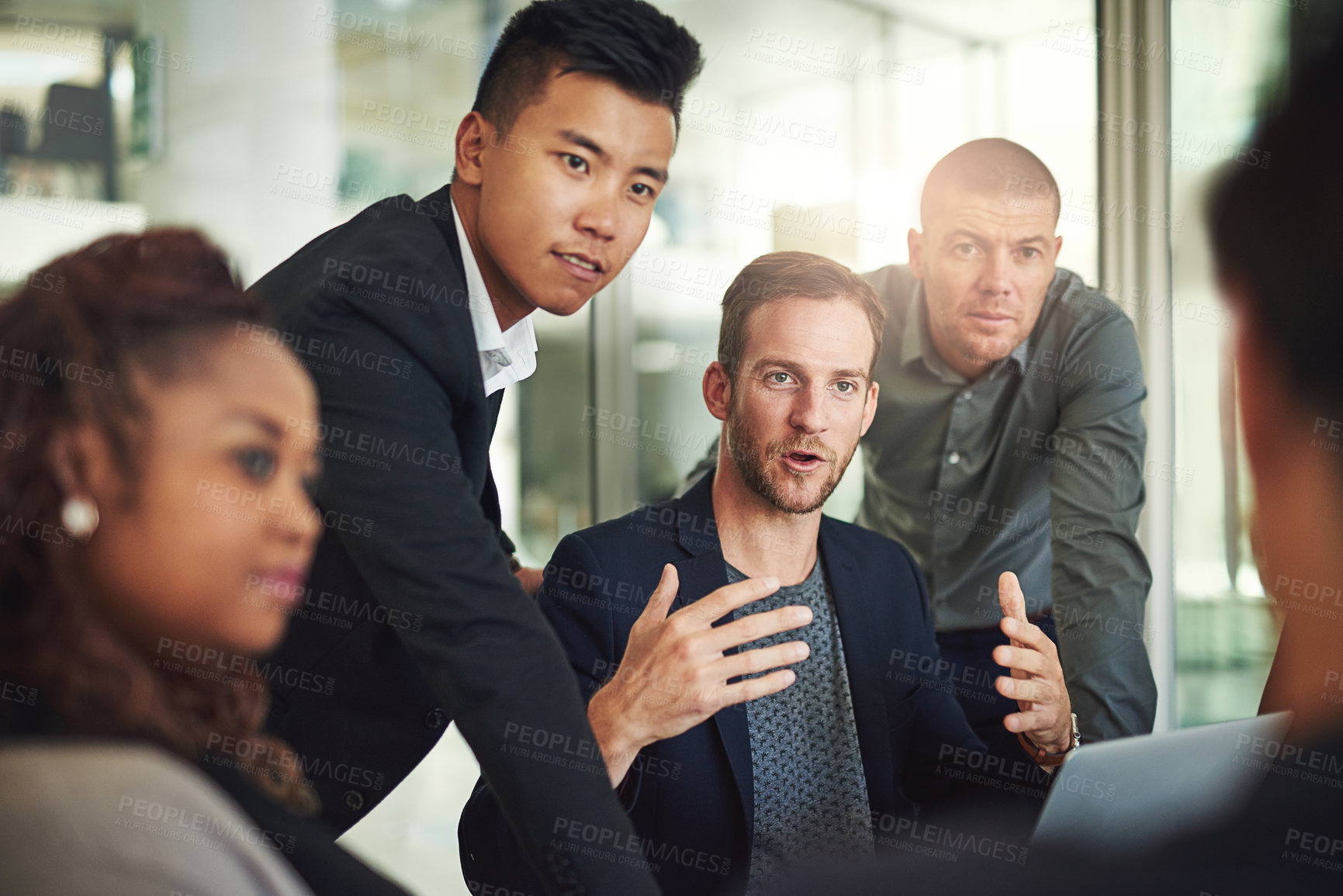 Buy stock photo Team, discussion and man in office with laptop, ideas and feedback on project management ideas. Leadership, diversity and group of business people in meeting with mentor, advice or planning strategy