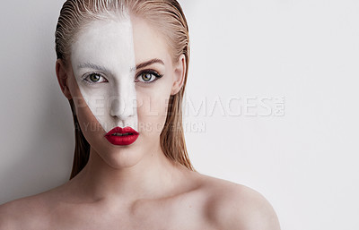 Buy stock photo Shot of a beautiful woman wearing face paint and red lipstick against a plain background