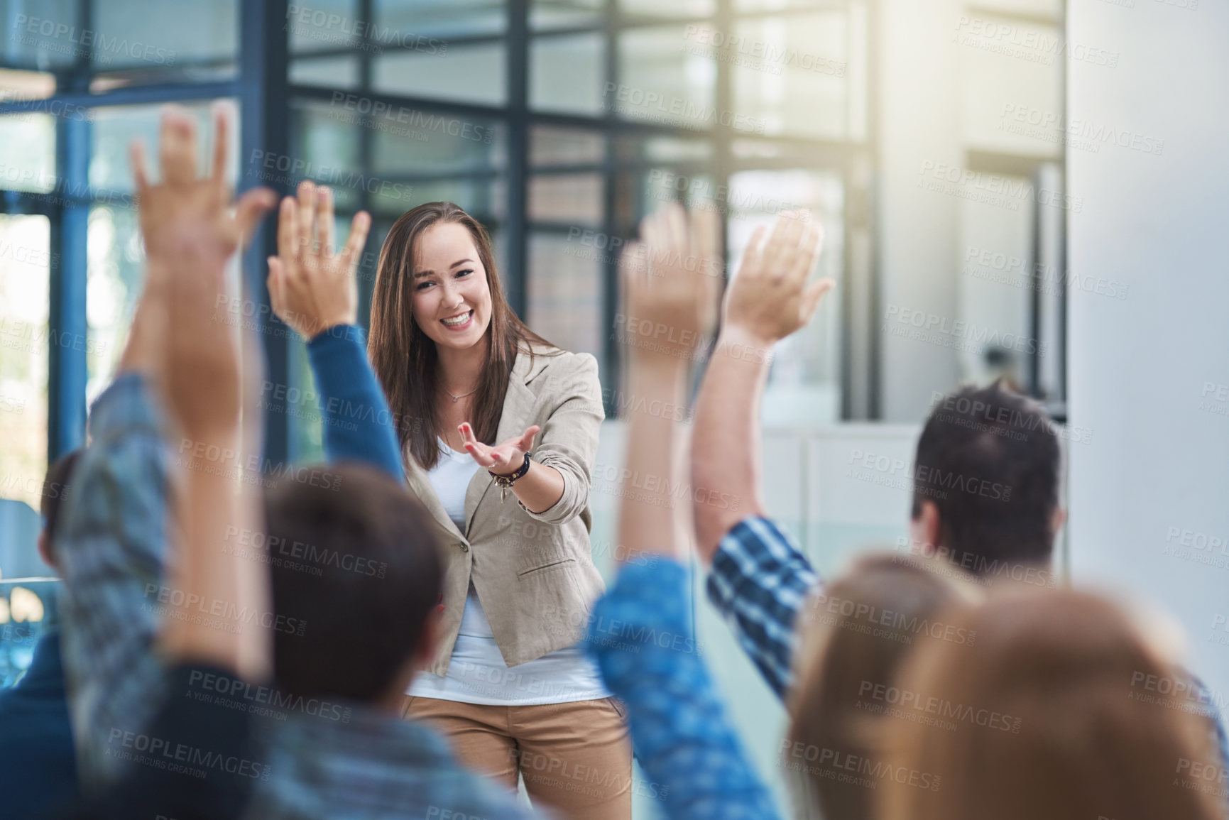 Buy stock photo Shot of a group of people raising their hands in a seminar